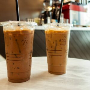 two coffee cups on a table in a coffee shop